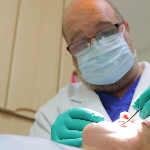 Dr. King performing a tooth filling diagnostic